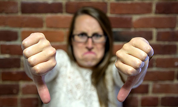 Photo of a girl giving the two thumbs down gesture