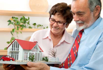 Photo of a senior couple looking at a model of their Louisville dream home