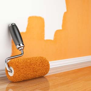 Photo of a paint roller and paint on the wall