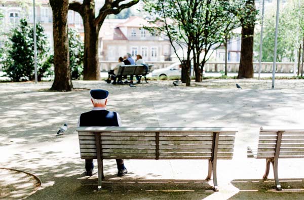 Photo of an older man on a park bench
