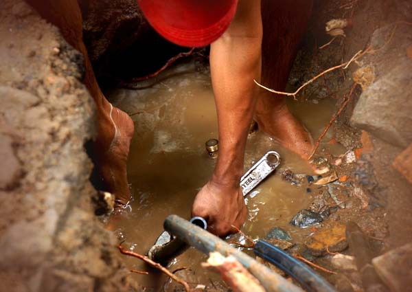 Photo of a plumber performing a repair