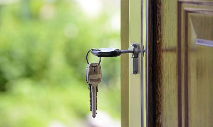 Photo of a key in a door - Inheriting a House? Choosing the Best Option for a Quick Sale