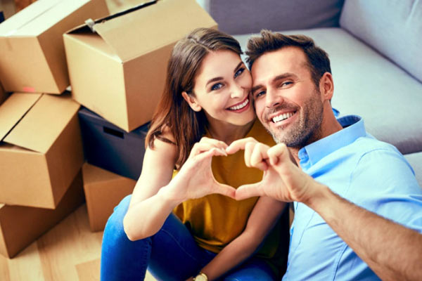Photo of a happy couple with moving boxes