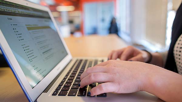 Photo of a person working on a laptop