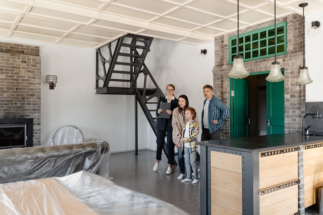 Photo of people viewing an industrial loft style condo