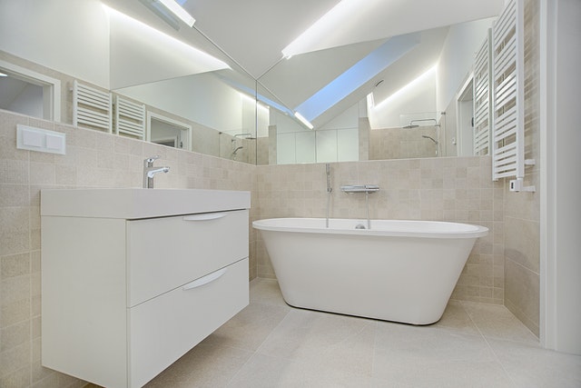Photo of a small bright bathroom with lots of mirrors