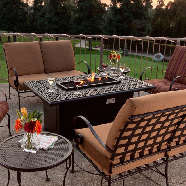 Photo of a patio with furniture and a fire feature