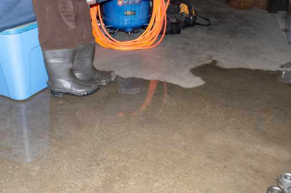 Photo of a basement floor with water on it