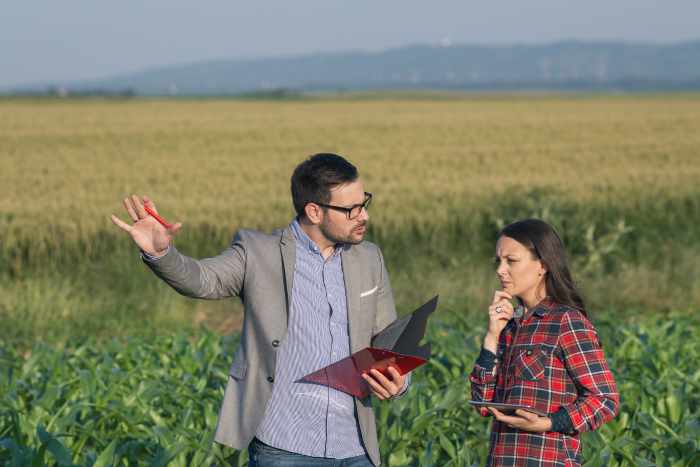 Photo of a real estate agent working with client selling lots of land