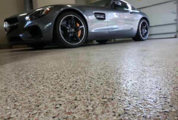 Photo of a garage with an epoxy floor and sports car