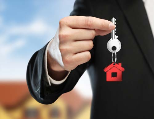 Photo of a real estate agent holding a house key