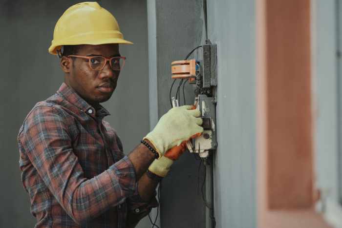 Photo of an electrician working on an electrical panel