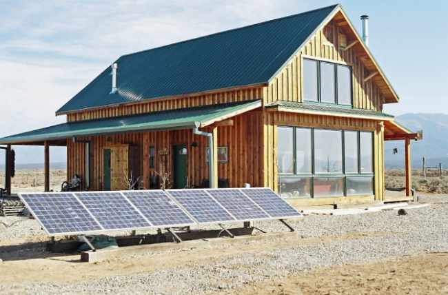 Photo of a home with solar panels. Living off the grid.