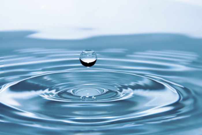 Photo of a waterdrop over water