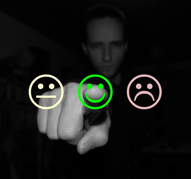 Man in shadow pointing at camera with rating face icons - Essential Guide to Creating a Positive Online Reputation for Your Business