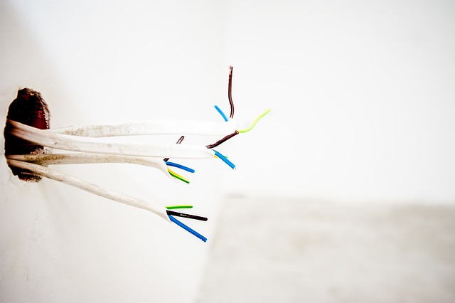 Photo of electrical wires coming out of a wall - 8 Common Electrical Problems and How to Solve Them