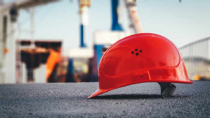 Photo of a red hard hat at a construction site