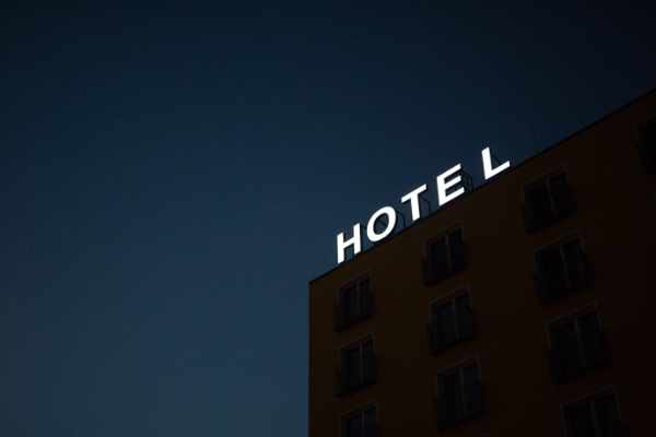 Photo of a hotel with a sign on top - Benefits of Home Insurance