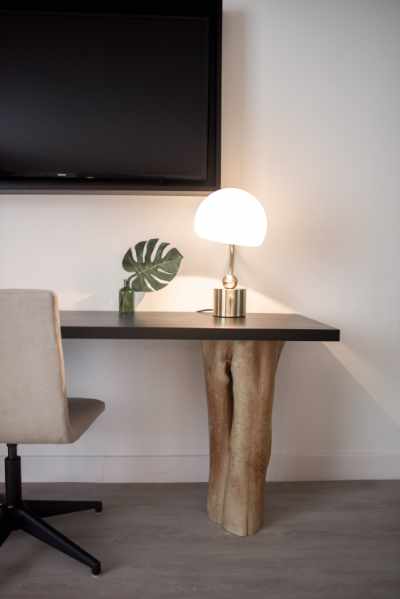 Photo of a desk designed with natural wood leg and a stone top
