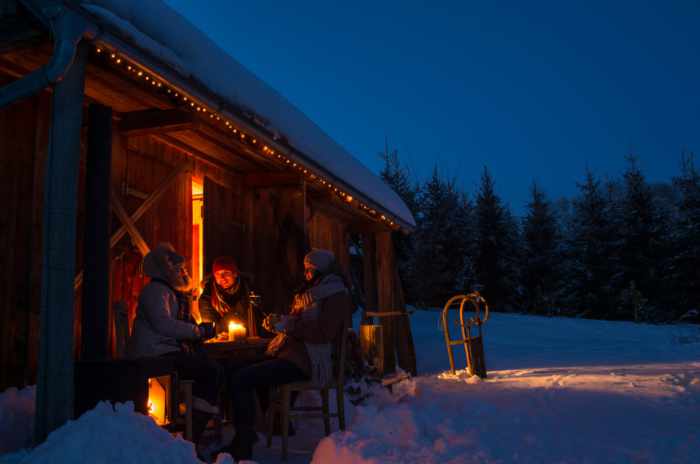 Photo of some people enjoying time at their cabin in the Winter