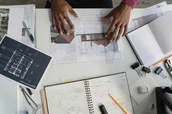 Photo of an architect working on plans for a luxury residential property - Top 5 Tools to Connect with Your Luxury Residential Architect