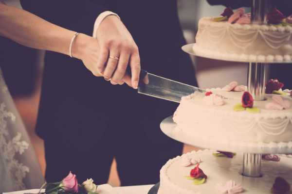 Photo of a wedding couple cutting the wedding cake