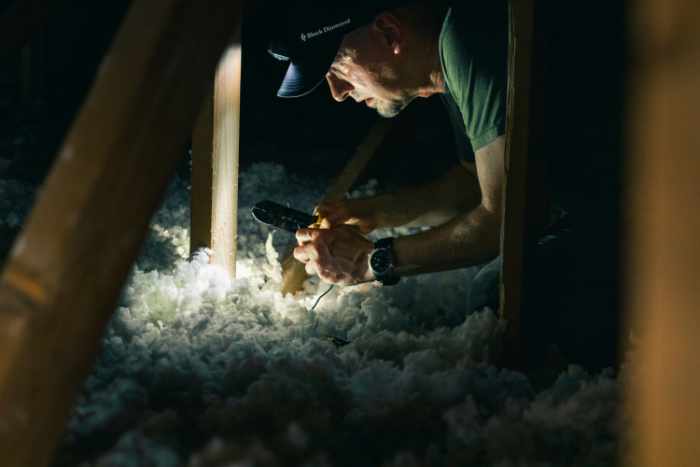 Photo of a contractor in an attic analyzing the insulation - 7 Smart Energy-Saving Tips for New Homeowners