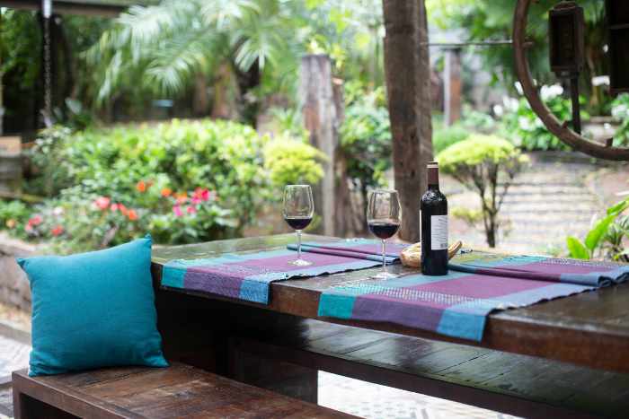 Outdoor patio with a dining table and a bottle of wine