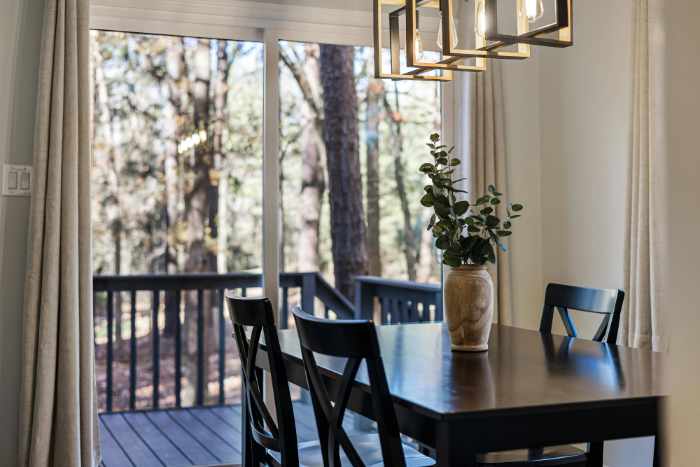 Photo of a dining room looking out onto a deck and backyard - The Art of Blending Functionality and Style in Home Renovations