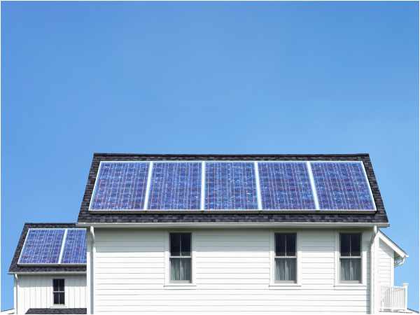 Photo of the back of a house with solar panels on the roof - How Energy-Efficient Products Boost Your Home's Value