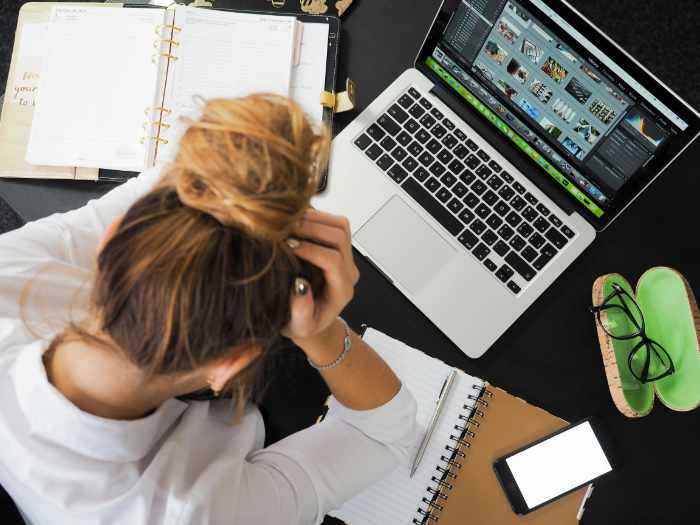 Photo of a stressed out woman at her laptop computer - How to Sell Your House Fast and Avoid Mortgage Stress