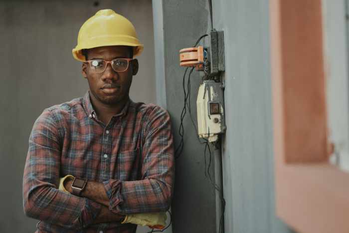 Photo of an electrician contractor with a yellow hardhat - How to Ensure Electrical Safety During Home Renovations