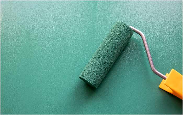 Photo of a paint roller with green paint - Choosing the Perfect Paint for Your Home: A Comprehensive Guide