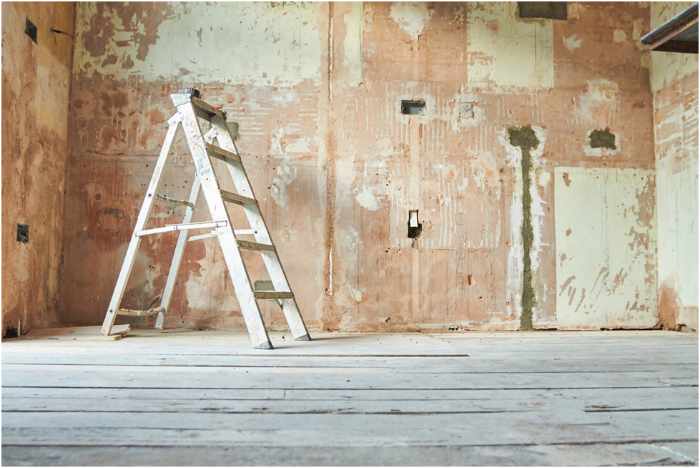 Photo of a living space being renovated with the drywall removed and a ladder - Sustainable Home Renovations: Transforming Spaces with the Planet in Mind