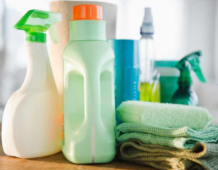 Photo of bottles of cleaners, detergent, towels and rags - Guide to Proper Household Chemical Storage