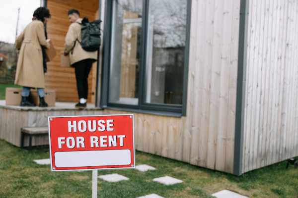 Photo of a landlord showing a tenant a house for rent - So You Want to Build a Rental Property Portfolio?