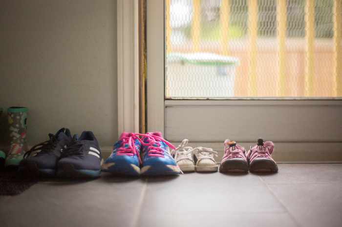 Photo of a series of kids shoes by the backdoor - Designing a Home that Grows with Your Family