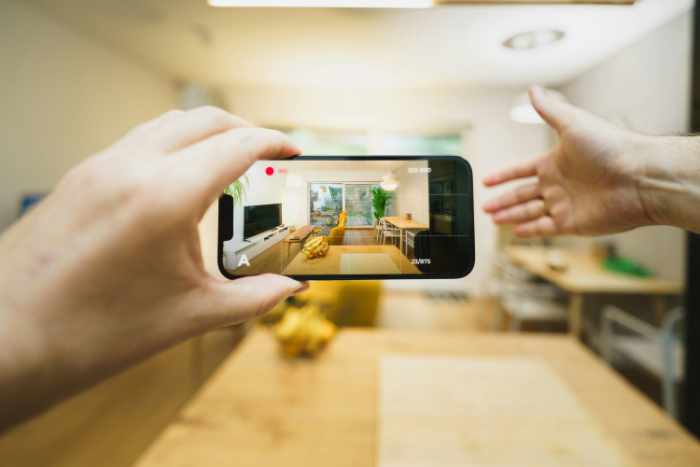 Photo of a photographer taking a real estate photo with his cellphone - Virtual Home Tours Can Power-up Your Real Estate Listings