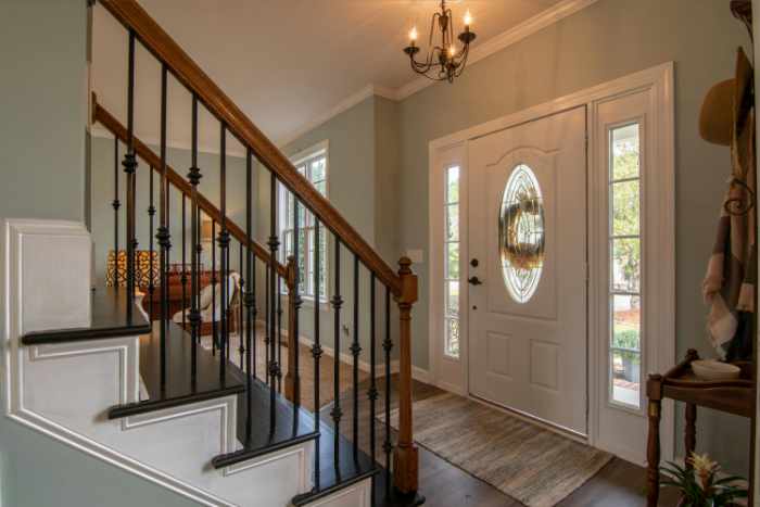 Photo of a home entry with staircase and front door - Flipping Houses for Profit