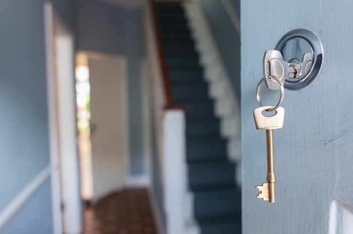 Photo of a key unlocking the front door to a home - Maximizing Your Home Value: Smart Strategies For A Stronger ROI