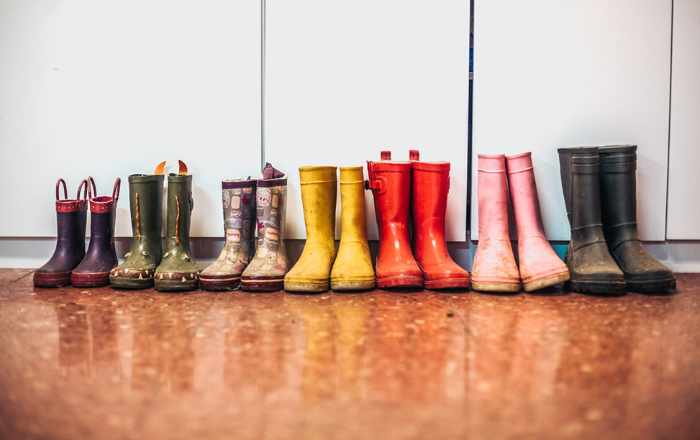 Photo of a row of boots from smallest to largest - 5 Steps for Health Safety after a Flood in Your Home