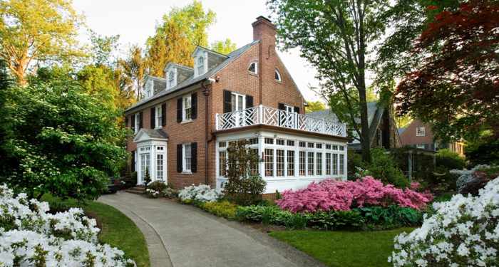 Photo of a traditional brick home with a sunroom - Key Exterior Home Maintenance That Protects Your Health