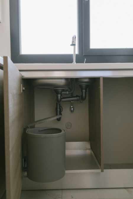 Photo of a kitchen sink and the plumbing pipes - The Hidden Plumbing Problems that Can Kill a Home Sale 