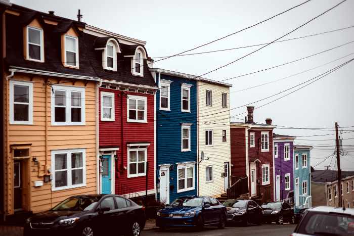 Photo of a row of colorful homes - Exterior House Painting Tips Every Homeowner Should Know Before Listing a Property