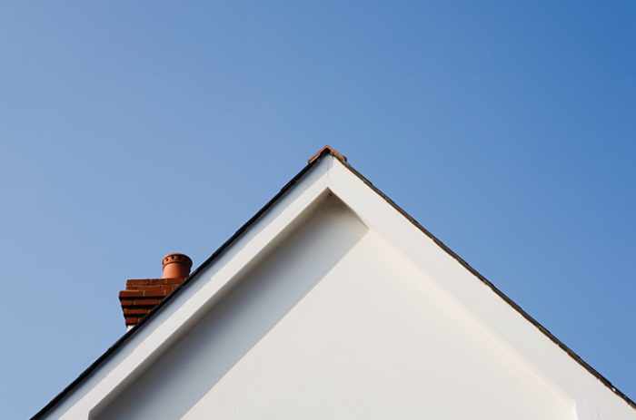Photo of a peak of a roof - The Homeowner's Guide to Finding Roof Leaks