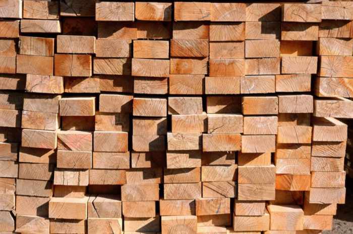Photo of a large stack of wood boards - The Hidden Weight of Construction Waste and Why It Matters