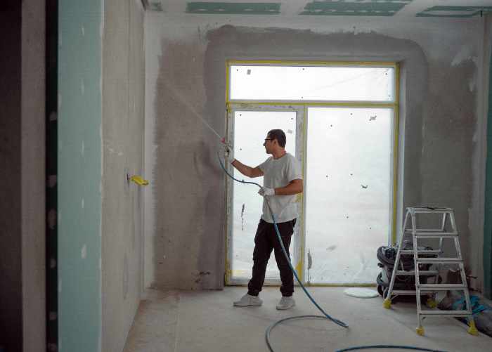 Photo of a contractor installing drywall - How to Choose the Best Contractor for Any Major Home Improvement Project